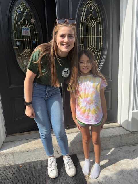 A teacher poses with her student 