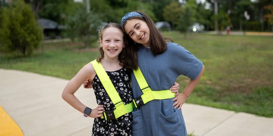 students smile while wearing their patrol belts