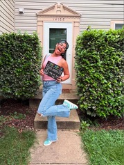 student smiling with sign