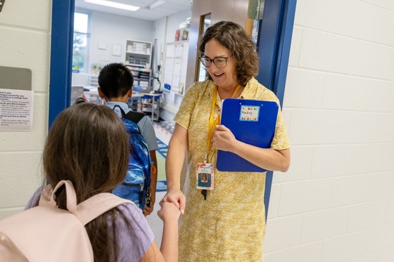 teacher smiles at student