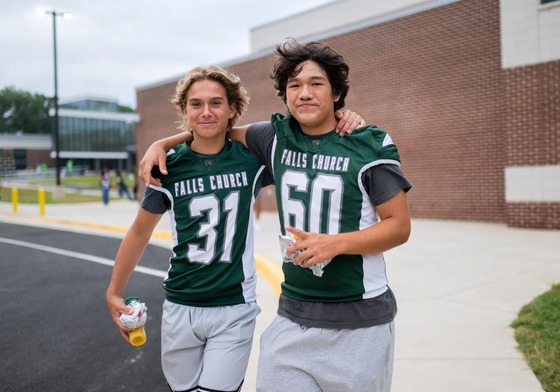 two football players hug on first day of school