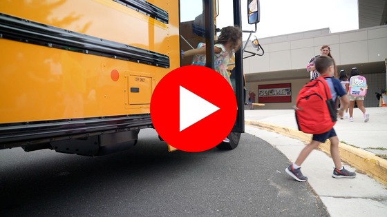 Screen shot of students getting off a bus