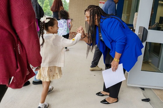 teacher high fiving student