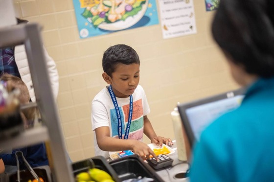 student getting food in a lunch line