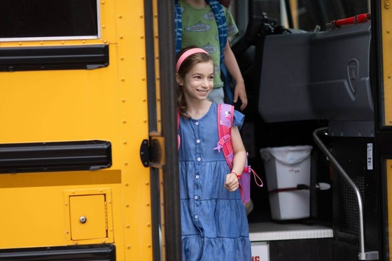 student getting off school bus