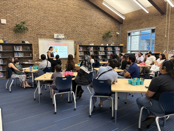 parents sitting in a library attenting the prek family orientation