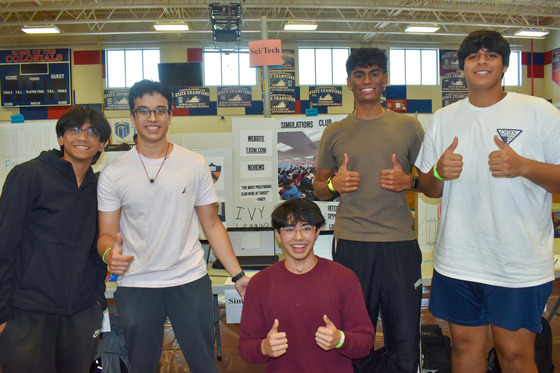 Students promoting their Simulations Club at the eighth period activity fair