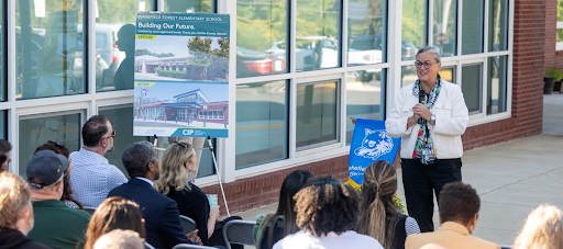 Dr. Reid speaks before a crowd outside of Wakefield Forest Elementary School