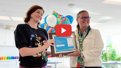 Screenshot of a woman receiving an award