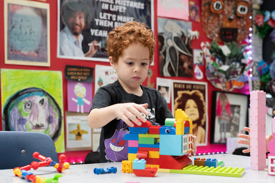 a young child plays with duplo blocks