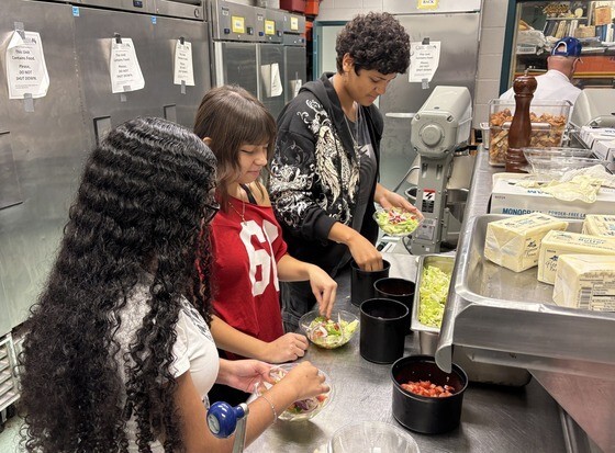 students preparing salads