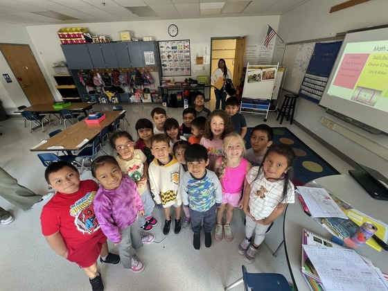 A 1st grade class stands together for a picture