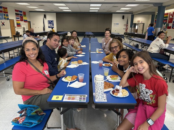 students and parents having breakfast in the cafeteria