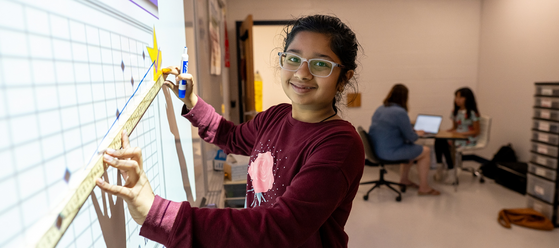 student using a ruler to measure