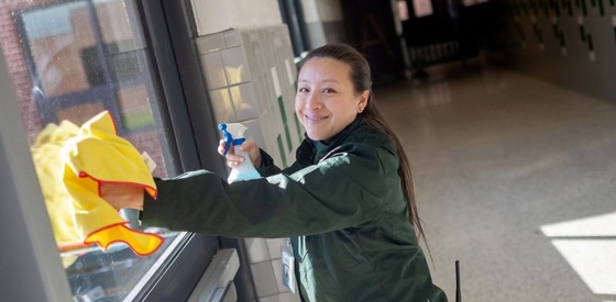 custodian cleaning windows