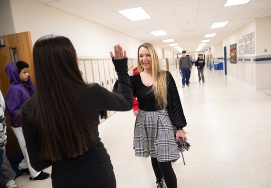 Principal Dr Aye of Fairfax HS in the halls with a student