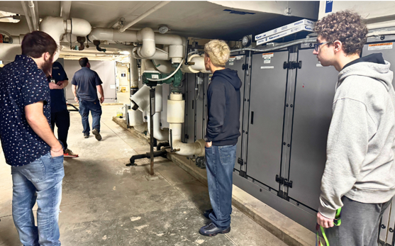 students view heating, ventilation, and air conditioning systems with Mount Vernon Estate employees