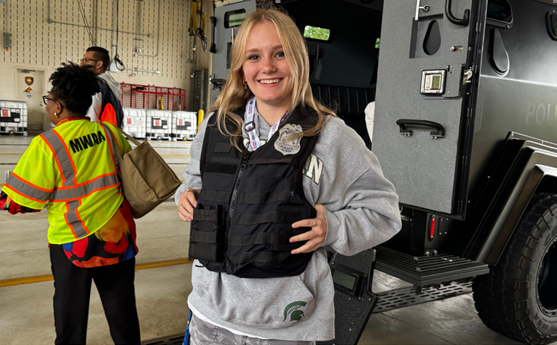 student trying on police vest