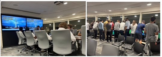 students standing and seated while learning about satellites
