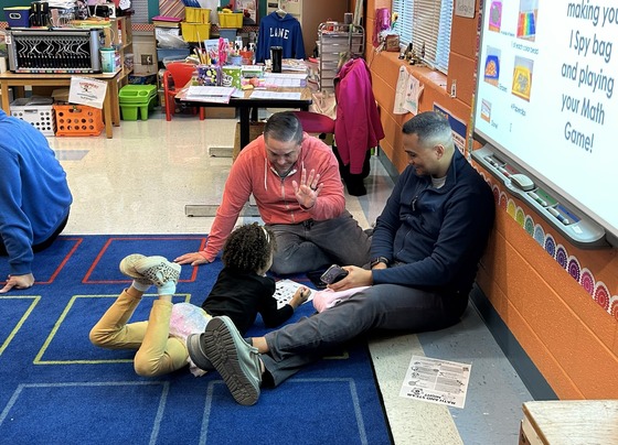 Student and parents play math game at Math & STEAM Night