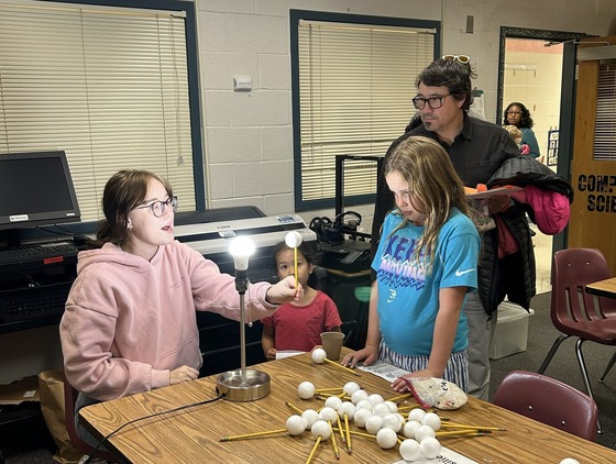 Teacher demonstrates how the earth revolves around the sun