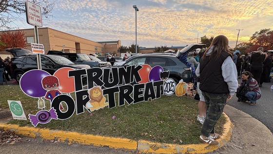 PTA Trunk or Treat sign with packed parking lot