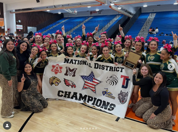 FCHS Cheer Team posing with National District Championship banner