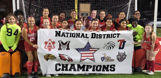 AHS Field Hockey Team posing with National District Championship banner