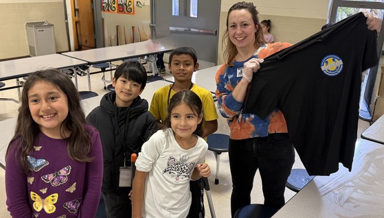 Parent holding a Brookfield shirt with students