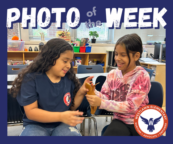 photo of the week: two girls pass a buckskin bootie between them