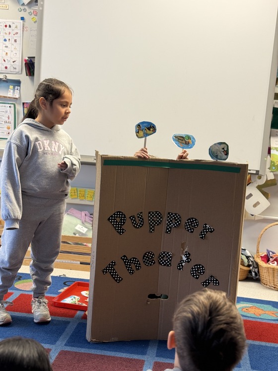 Students perform for a puppet theater 