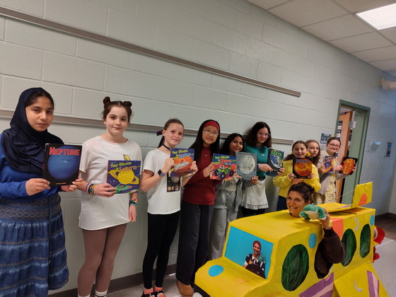 Students are dressed as planets with Magic School bus 