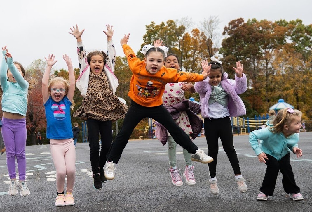 students jumping on the playground