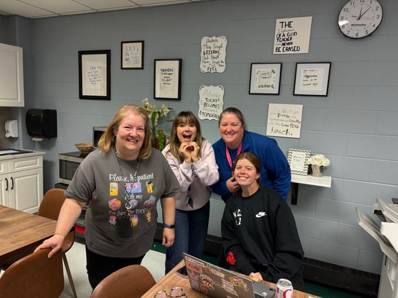 Fairview staff smiling in new teachers lounge
