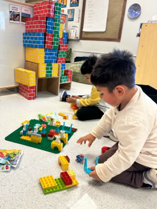 A student builds with legos 