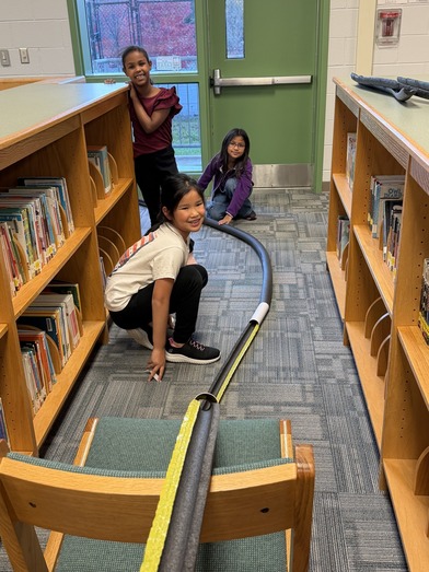 Three girls build a track during afternoon clubs 