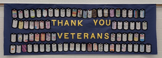 Thank You banner for veterans with dog tags made by students