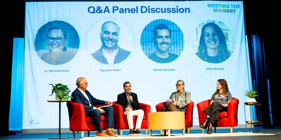 AI event speakers on stage for panel