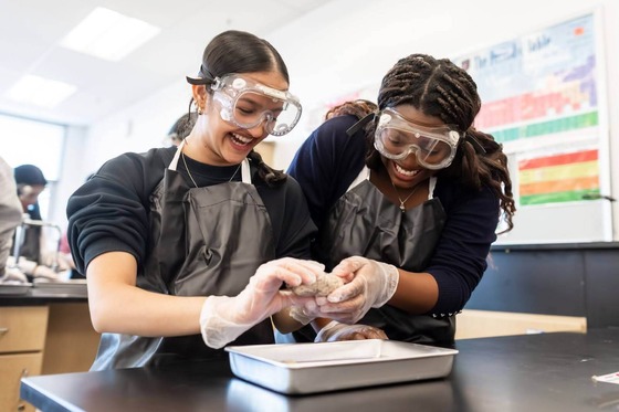 two students enjoying a hands on science lesson