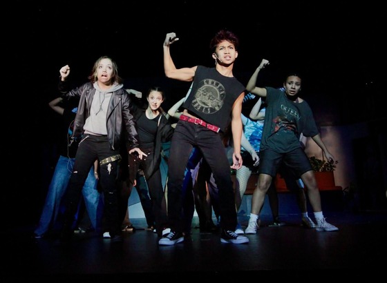 students performing on stage