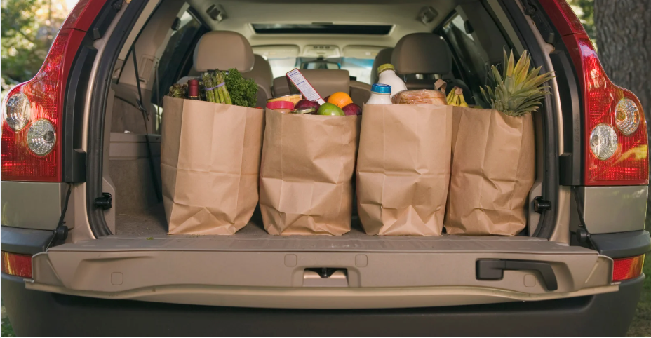 brown paper grocery bags in the back of a car