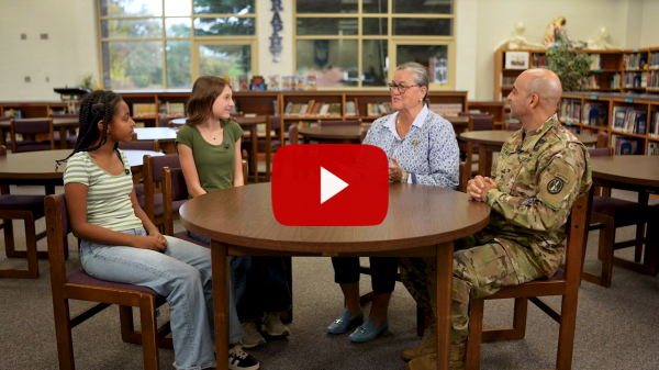 Students talk to Superintendent and Garrison Commander in a library