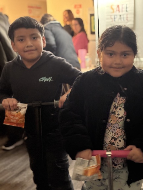 Two students smile at a parent workshop 