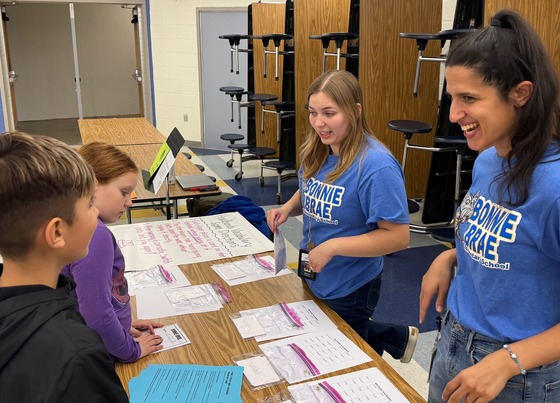 Students and staff at a literacy station