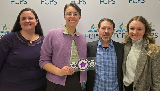 saff posing with purple star award