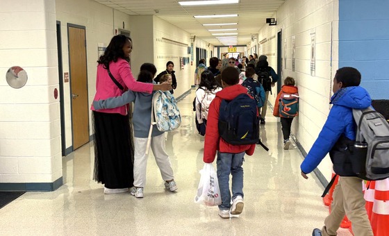 Student hugging Mrs. Opie during morning arrival