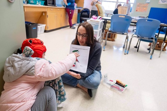 teacher teaching a student