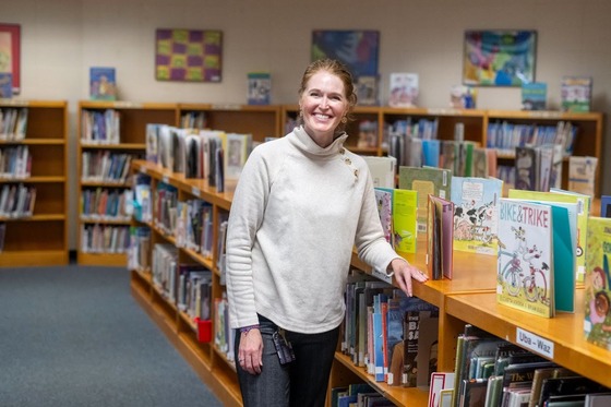 teacher smiles in the library