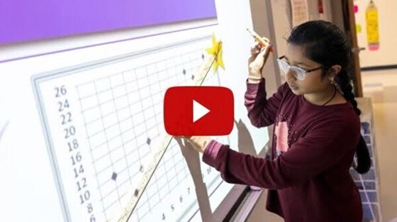 child working on classroom smartboard