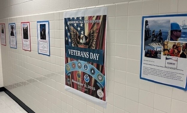 hallway displaying Veterans Day poster and student work